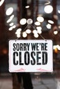 Inscription on metal plate sorry we are closed sign on glass door business office, store or restaurant coronavirus Royalty Free Stock Photo