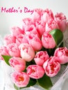 Inscription mothers day with bunch of light gentle pink tulip, bouquet flowers Royalty Free Stock Photo