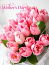 Inscription mothers day with bunch of light gentle pink tulip, bouquet flowers Royalty Free Stock Photo