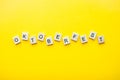 The inscription octoberfest from wooden blocks on a bright yellow background