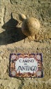 Inscription on an old stone wall `Camino de Santiago` Pilgrimage of Compostela with original gourd, Spain