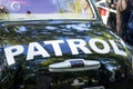 The inscription PATROL on a police car. A partial view of a patrol car zoomed in on the word