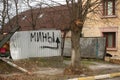 Inscription `People` on the fence of a private house in Bucha during russian army occupation