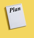 Inscription PLAN written on note paper on a bright yellow background Royalty Free Stock Photo