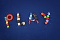 Inscription PLAY made from different toys on blue textile background. Childhood concept. Good for baby store