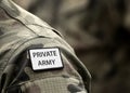 Inscription Private Army on military uniform. Inscription Private Army on soldier arm. Private military