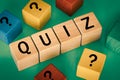 The inscription Quiz on wooden blocks other blocks with question marks, the concept of questions and answers in game shows and
