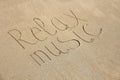 The inscription of relax music is painted on the sand Royalty Free Stock Photo