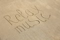 The inscription of relax music is painted on the sand Royalty Free Stock Photo