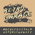 The inscription retro garage with black shadows on a background of gray blots. Letters in retro style. English alphabet