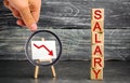 The inscription `salary` and the red arrow down. lower salary, wage rates. demotion, career decline. lowering the standard of livi Royalty Free Stock Photo