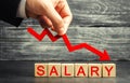 The inscription salary and the red arrow down. lower salary, wage rates. demotion, career decline. lowering the standard of livin Royalty Free Stock Photo