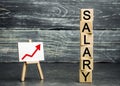 The inscription salary and the red arrow up. increase of salary, wage rates. promotion, career growth. raising the standard of Royalty Free Stock Photo