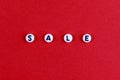 The inscription SALE on a red paper background. Advertising, postcard, banner