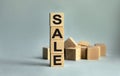 The inscription SALE on wooden cubes isolated on a light background. The image symbolizes the beginning of the new year