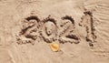 2021 inscription on the sand of the beach. Summer beach holidays in 2021. The message is handwritten Royalty Free Stock Photo