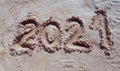 2021 inscription on the sand of the beach. Summer beach holidays in 2021. The message is handwritten Royalty Free Stock Photo