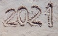 2021 inscription on the sand of the beach. Summer beach holidays in 2021. The message is handwritten Royalty Free Stock Photo