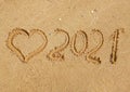 2021 inscription on the sand of the beach. Summer beach holidays in 2021. The message is handwritten. The concept of the new year Royalty Free Stock Photo