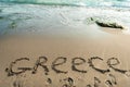 Inscription on the sand Greece, sea water Royalty Free Stock Photo