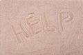 The inscription on the sand Help, close-up Royalty Free Stock Photo