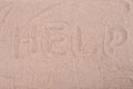 The inscription on the sand Help, close-up Royalty Free Stock Photo