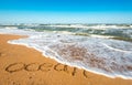 Inscription on sand summer near stormy sea wave Royalty Free Stock Photo