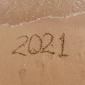 inscription on the sand 2021. symbol 2021 on the coast, overlooking the sea. Summer holidays in the new season. Royalty Free Stock Photo