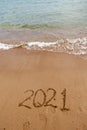 inscription on the sand 2021. symbol 2021 on the coast, overlooking the sea. Summer holidays in the new season. Royalty Free Stock Photo