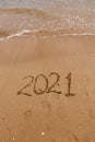 inscription on the sand 2021. symbol 2021 on the coast, overlooking the sea. Summer holidays in the new season. Royalty Free Stock Photo