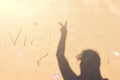 inscription on the sea coast of Vietnam 2020. silhouette of a girl on the sand