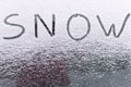 The inscription SNOW on the glass of the frozen car . Snowfall