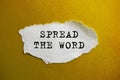 The inscription SPREAD THE WORD on torn paper. Marketing conceptual word on yellow background