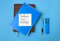 Inscription on the sticker work at home on a blue background, a notebook