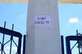 The inscription stop covid-19 on the column of the quarantined stadium