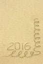 Inscription 2016 and streamers in the sand on the beach Royalty Free Stock Photo