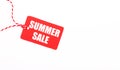 The inscription SUMMER SALE on a red price tag on a light background. Advertising concept. Copy space Royalty Free Stock Photo