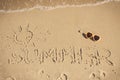 Inscription summer with shape of sun and sunglasses on sand at beach. Vacation time Royalty Free Stock Photo