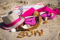 Inscription sun made of amber and different accessories for relax on sand. Straw hat, slippers and towel. Summer time on beach Royalty Free Stock Photo