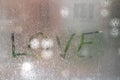 Inscription on sweaty glass with drops - love Royalty Free Stock Photo