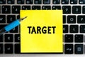 inscription `TARGET` on a yellow sheet of sticker paper on the background of a computer keyboard