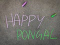 The inscription text on the grey board, Happy Pongal.
