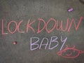 Lockdown baby with hand drawn baby head. Using color chalk pieces Royalty Free Stock Photo