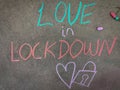 Love in lockdown with hand drawn love symbol and lock. Using color chalk pieces Royalty Free Stock Photo