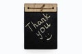 The inscription thank you is written in chalk on a black board on a white background Royalty Free Stock Photo