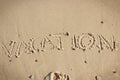 Inscription vacation on sand at beach. Summer time Royalty Free Stock Photo