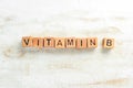 The inscription `VITAMIN B` is laid out of wooden cubes.