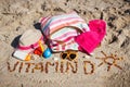 Inscription vitamin D, accessories for relax and childrens playing on sand at beach. Prevention of vitamin D deficiency. Healthy Royalty Free Stock Photo