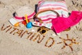 Inscription vitamin D, accessories for relax and childrens playing on sand at beach. Prevention of vitamin D deficiency Royalty Free Stock Photo
