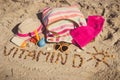 Inscription vitamin D, shape of sun and accessories for relax on sand at beach. Prevention of vitamin D deficiency and healthy Royalty Free Stock Photo